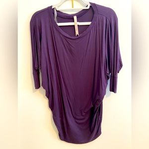 Purple three quarter sleeve loose fitting top.